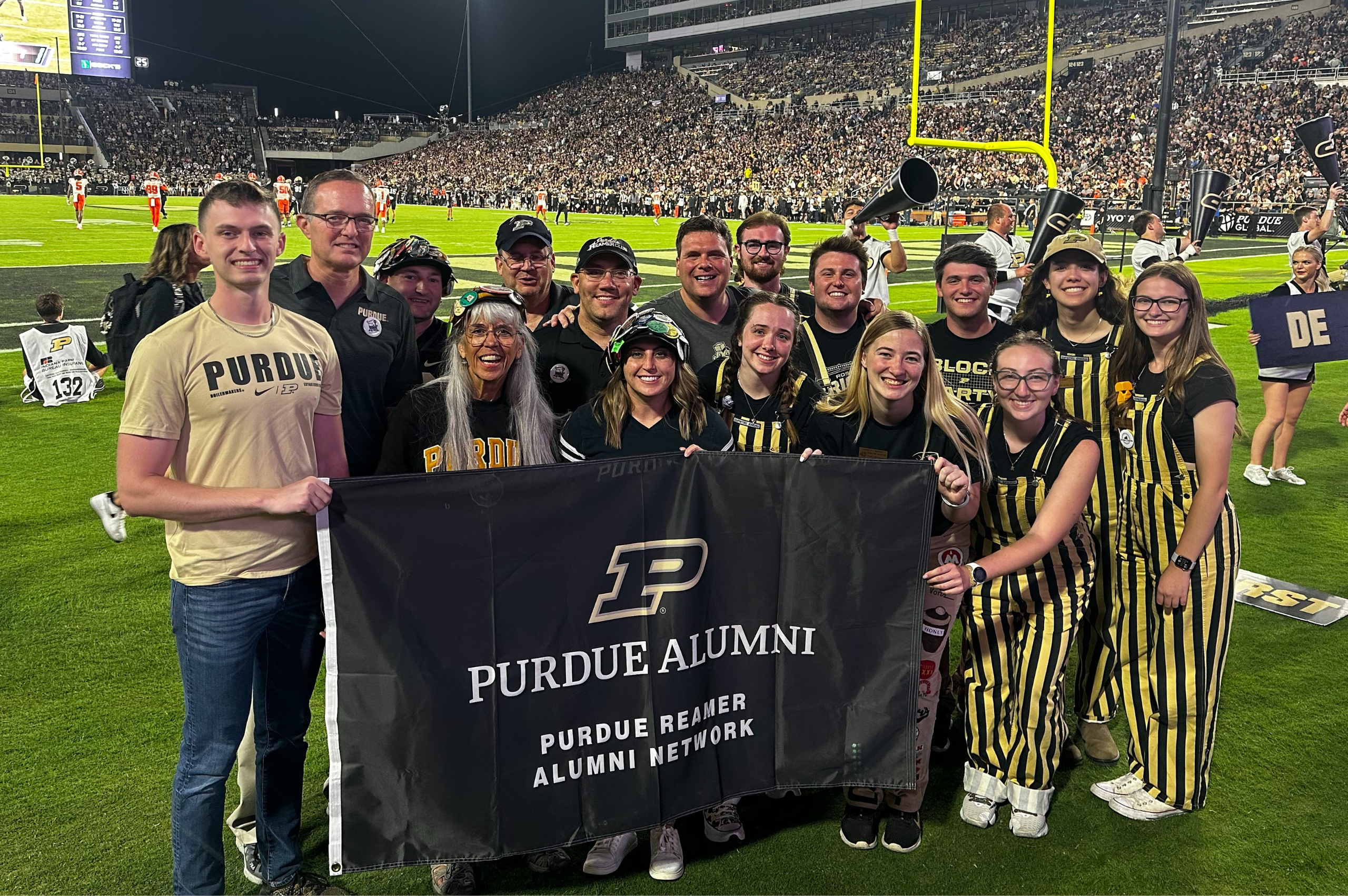 Group of Reamer Alumni and Active Reamers on the football field